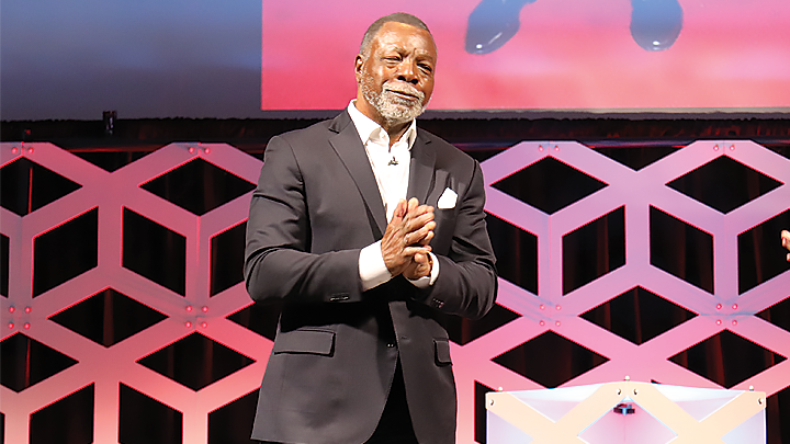 SDSU alumnus Carl Weathers clasps his hands and smiles at the maximum capacity audience during the SDSU President’s Lecture Series at Montezuma Hall, Feb. 2, 2023. (Mario Sevilla/SDSU)