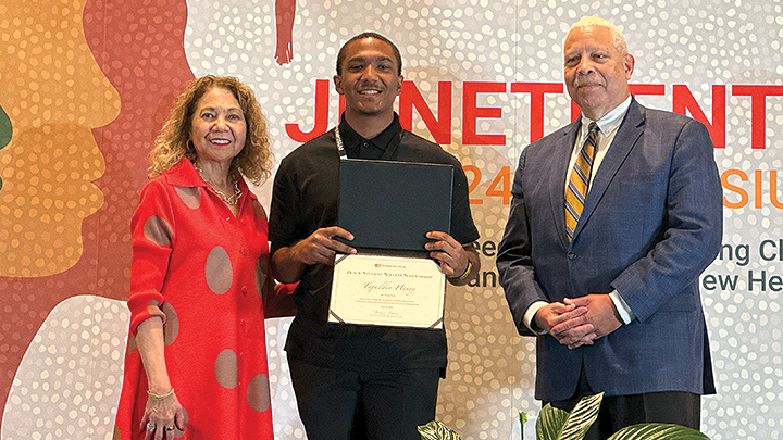 SDSU student Tajuddin Henry is joined by California State University Chancellor Mildred García and Jack Clarke, chair of the CSU Board of Trustees, during the Black Student Success Scholarship ceremony at the 2024 CSU Juneteenth Symposium, Friday, June 14, 2024. (Raquel Herriott/SDSU)