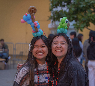 balloon animals on peoples' heads